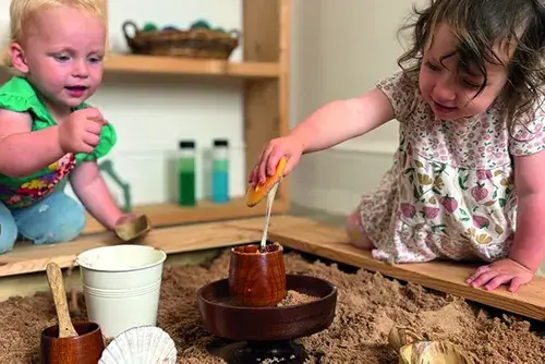 Children using spoons for sensory play in an early years setting