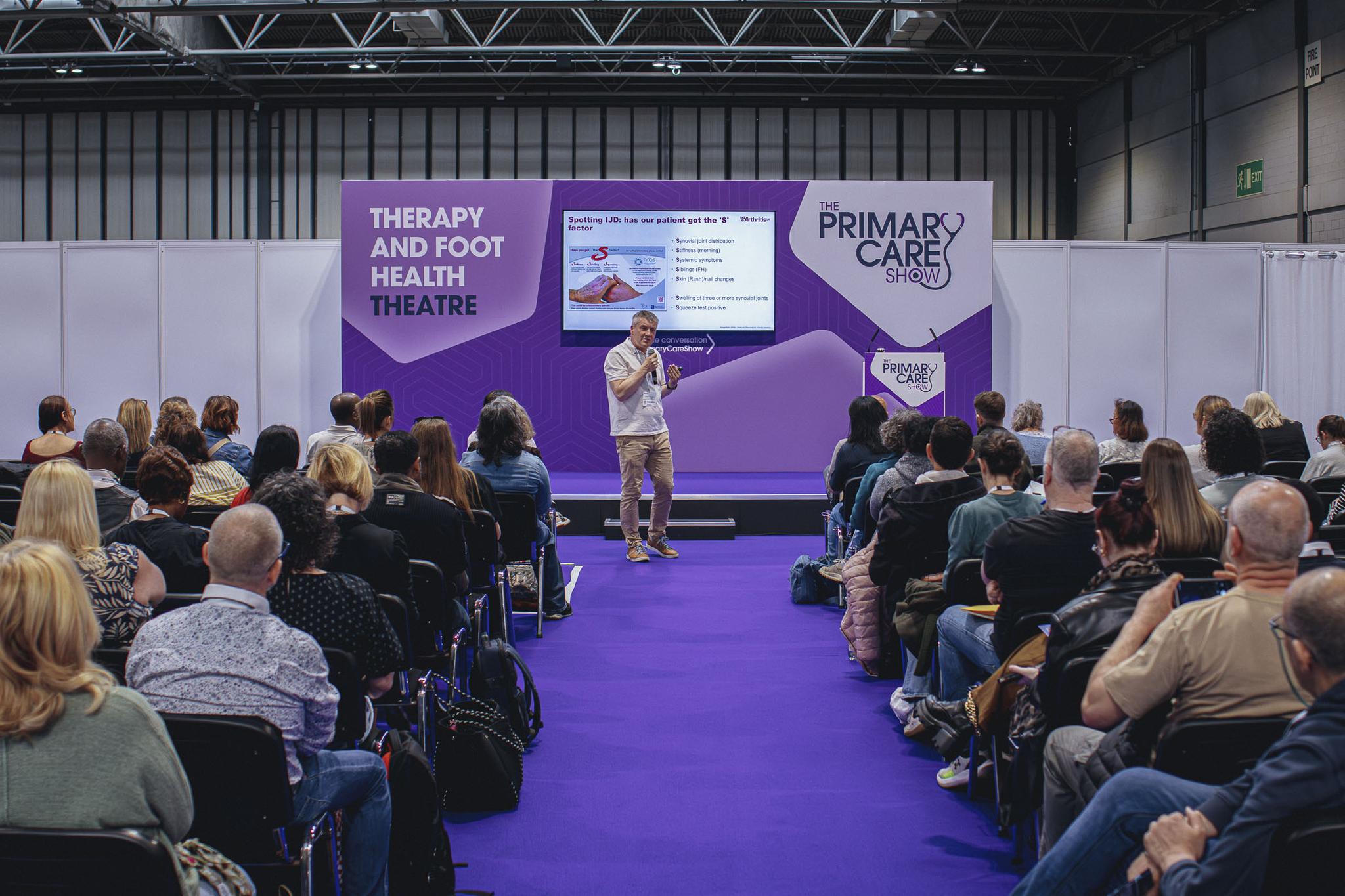 Expert speaker presenting in a healthcare conference theatre