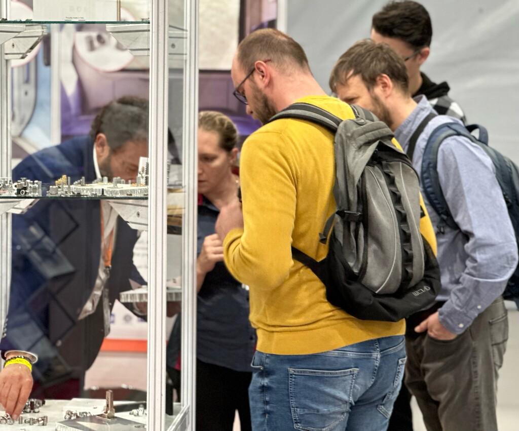 Visitors examining products on display