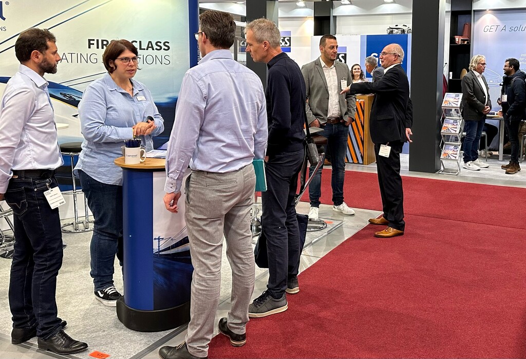 Rail industry professionals networking at an exhibitor stand