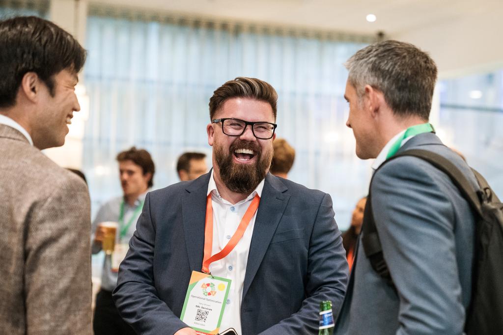 Happy delegate laughing inconversation