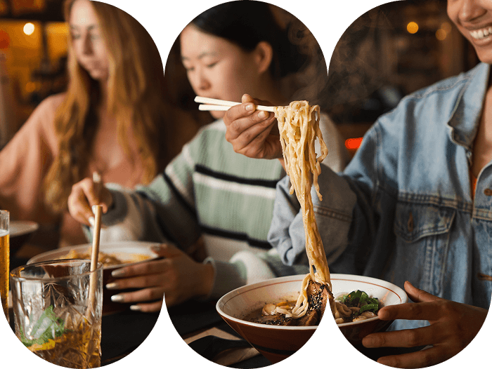 Woman lifting delicious steaming hot ramen noodles with chopsticks